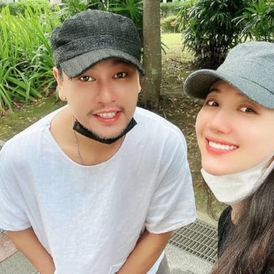 They both have taken their mask off as they are taking a selfie.